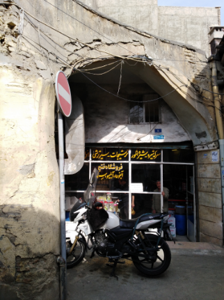 a very old store and a motorcycle in front of it